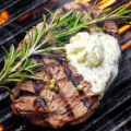 steak with butter on grill